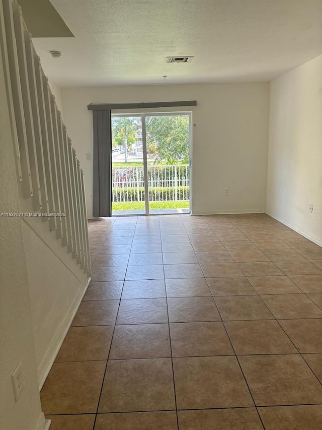 2050 NE 167th St Unit 3-124, North Miami Beach, FL 33162 - spare room with tile patterned floors and a textured ceiling
