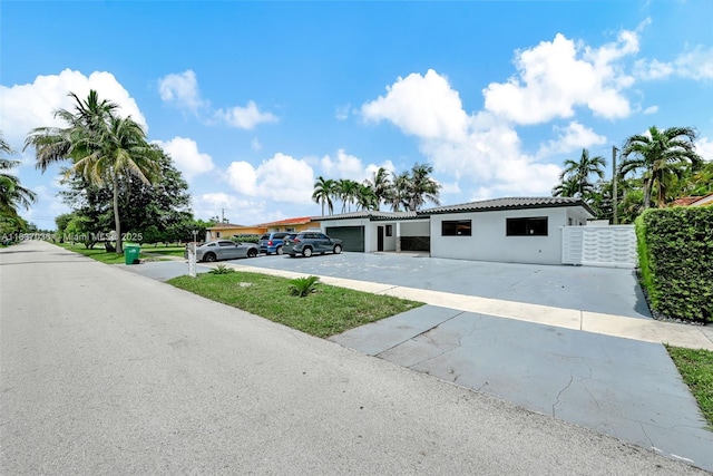 11055 NW 59th Ct, Hialeah, FL 33012 - view of front of property with stucco siding and concrete driveway