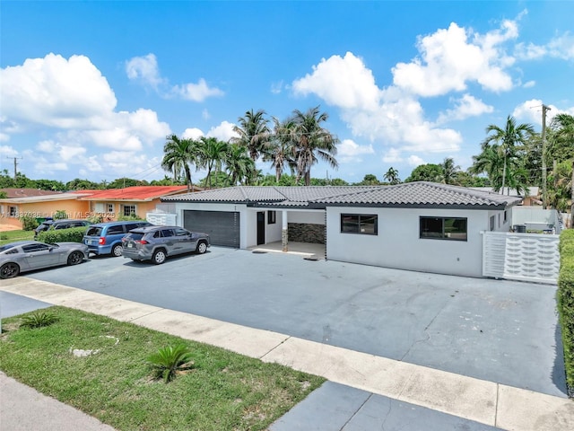11055 NW 59th Ct, Hialeah, FL 33012 - view of front facade featuring a tiled roof, stucco siding, and concrete driveway
