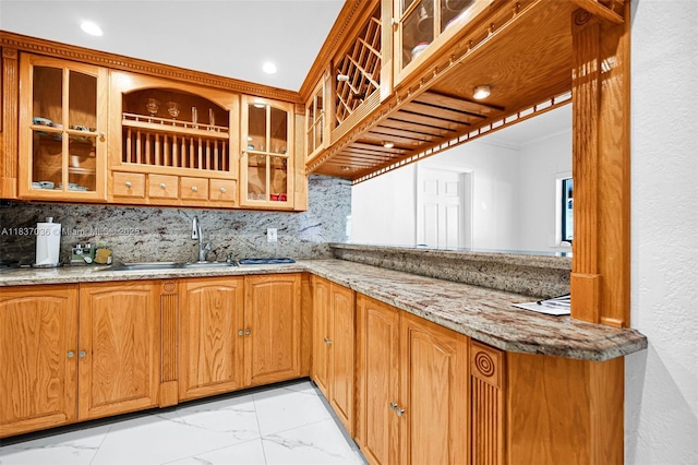 11055 NW 59th Ct, Hialeah, FL 33012 - kitchen featuring light marble finish floors, crown molding, backsplash, light stone counters, and glass insert cabinets