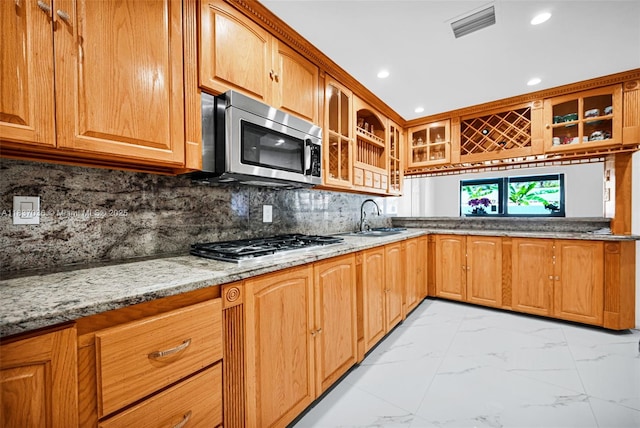 11055 NW 59th Ct, Hialeah, FL 33012 - kitchen with stainless steel appliances, light marble finish flooring, glass insert cabinets, light stone countertops, and recessed lighting