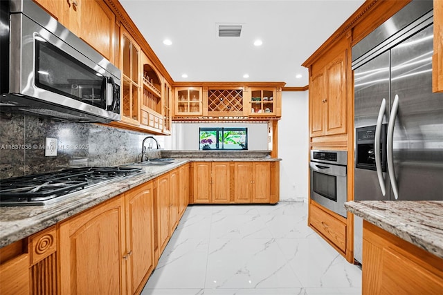 11055 NW 59th Ct, Hialeah, FL 33012 - kitchen featuring appliances with stainless steel finishes, light marble finish floors, light stone counters, backsplash, and recessed lighting