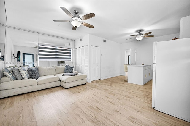 11055 NW 59th Ct, Hialeah, FL 33012 - living area with a ceiling fan and light wood-type flooring