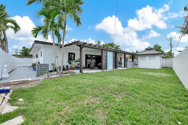 11055 NW 59th Ct, Hialeah, FL 33012 - back of property with a fenced backyard, a patio area, stucco siding, and a tile roof