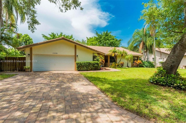 11321 NW 1st Ct, Coral Springs, FL 33071 - ranch-style home featuring a front yard, a garage, decorative driveway, and stucco siding