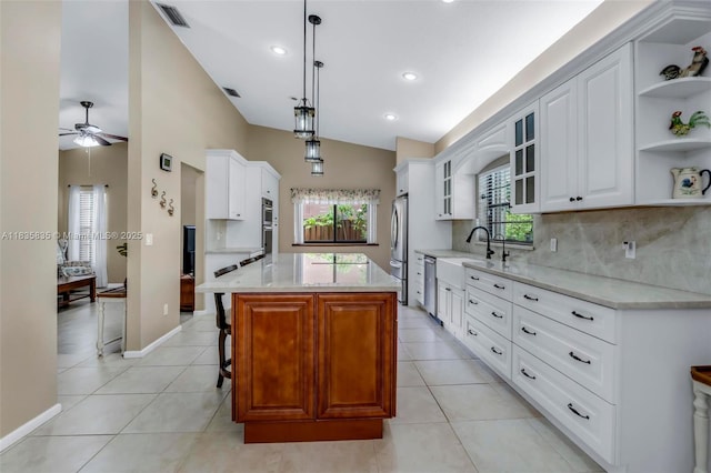 11321 NW 1st Ct, Coral Springs, FL 33071 - kitchen with open shelves, ceiling fan, light tile patterned floors, appliances with stainless steel finishes, and decorative backsplash