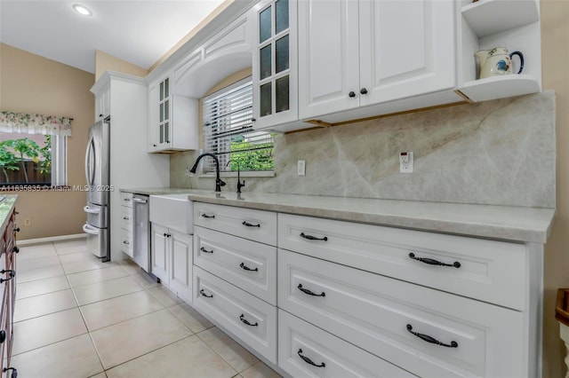 11321 NW 1st Ct, Coral Springs, FL 33071 - kitchen with stainless steel appliances, tasteful backsplash, white cabinets, light tile patterned flooring, and recessed lighting