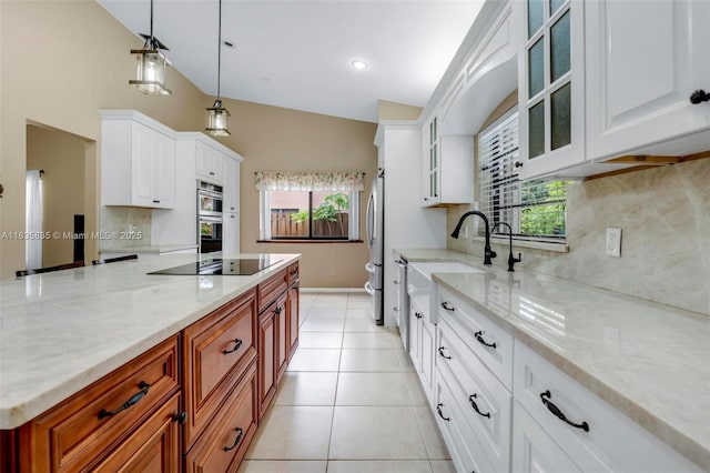 11321 NW 1st Ct, Coral Springs, FL 33071 - kitchen with black electric cooktop, tasteful backsplash, stainless steel double oven, light stone countertops, and vaulted ceiling