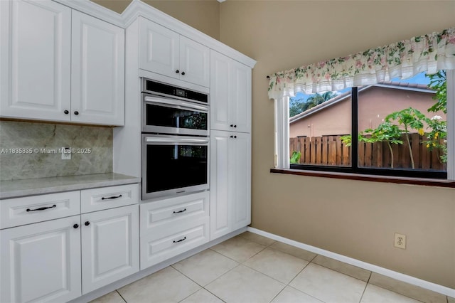 11321 NW 1st Ct, Coral Springs, FL 33071 - kitchen featuring stainless steel double oven, decorative backsplash, white cabinetry, and light tile patterned floors