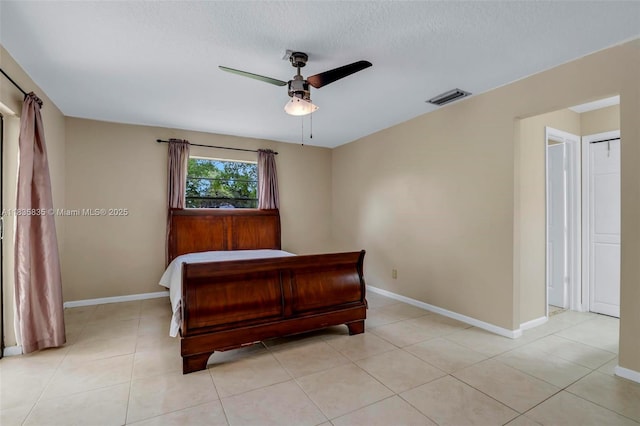 11321 NW 1st Ct, Coral Springs, FL 33071 - bedroom with a ceiling fan, light tile patterned floors, and a textured ceiling