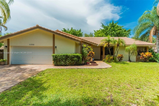 11321 NW 1st Ct, Coral Springs, FL 33071 - ranch-style house featuring a tile roof, an attached garage, driveway, and a front yard