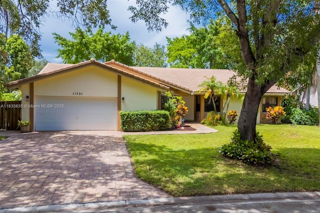 11321 NW 1st Ct, Coral Springs, FL 33071 - view of front of house featuring a tile roof, a garage, a front lawn, decorative driveway, and stucco siding