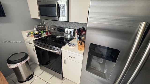 1244 NW 171st Ave, Pembroke Pines, FL 33028 - kitchen with appliances with stainless steel finishes, white cabinets, light countertops, tasteful backsplash, and light tile patterned floors