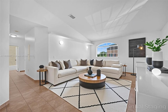 7506 W 20th Ave Unit 206, Hialeah, FL 33016 - tiled living room with baseboards and vaulted ceiling