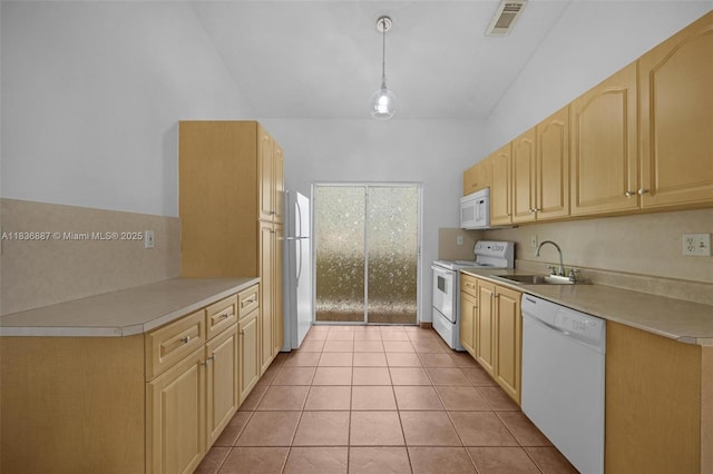 7506 W 20th Ave Unit 206, Hialeah, FL 33016 - kitchen with white appliances, light countertops, light tile patterned floors, and light brown cabinets