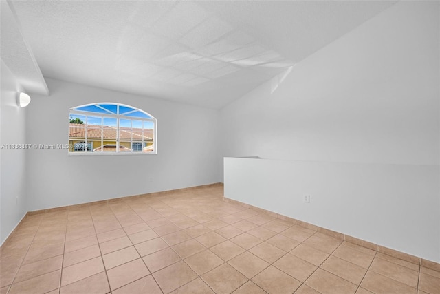 7506 W 20th Ave Unit 206, Hialeah, FL 33016 - empty room featuring tile patterned flooring and vaulted ceiling