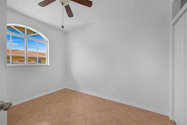 7506 W 20th Ave Unit 206, Hialeah, FL 33016 - spare room featuring a ceiling fan, a textured ceiling, and light tile patterned floors