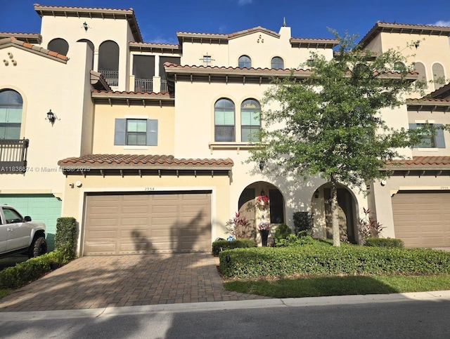 2954 NW 124th Way, Sunrise, FL 33323 - mediterranean / spanish home featuring stucco siding, decorative driveway, and an attached garage