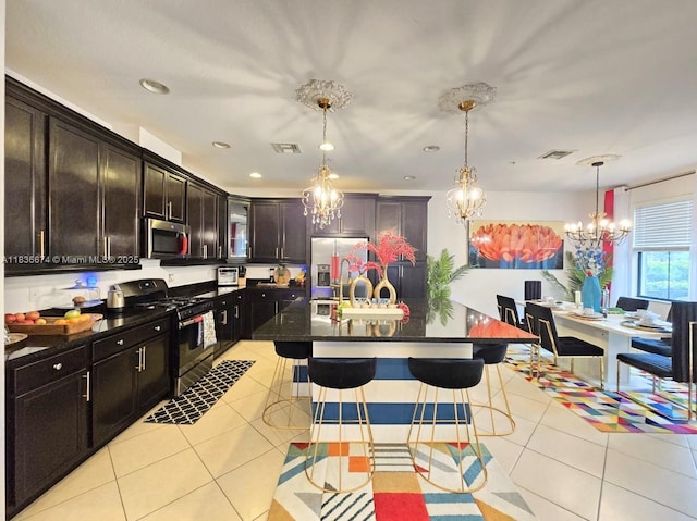 2954 NW 124th Way, Sunrise, FL 33323 - kitchen featuring stainless steel appliances, a chandelier, a kitchen bar, light tile patterned floors, and recessed lighting