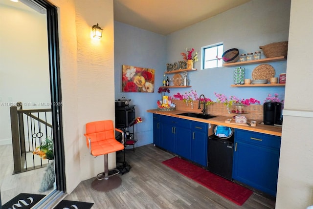2954 NW 124th Way, Sunrise, FL 33323 - kitchen with blue cabinetry, open shelves, wood finished floors, and backsplash