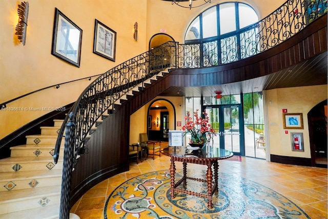 2954 NW 124th Way, Sunrise, FL 33323 - entryway with arched walkways, a towering ceiling, french doors, and stairs