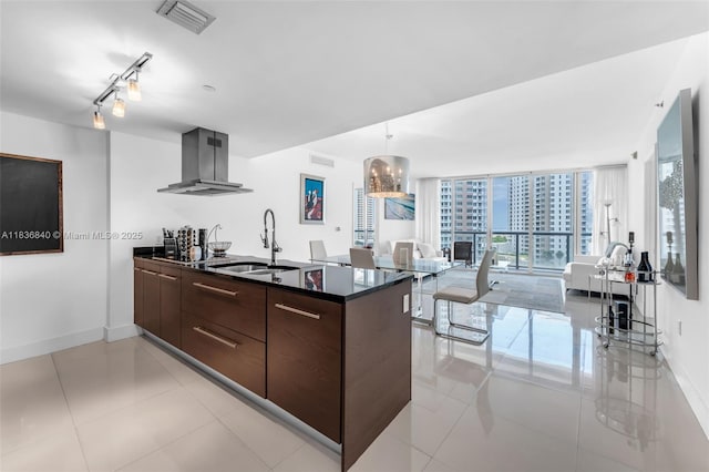 495 Brickell Ave Unit Bay1007, Miami, FL 33131 - kitchen with ventilation hood, modern cabinets, dark countertops, dark brown cabinetry, and open floor plan