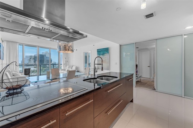 495 Brickell Ave Unit Bay1007, Miami, FL 33131 - kitchen featuring modern cabinets, wall chimney exhaust hood, electric stovetop, and light tile patterned floors