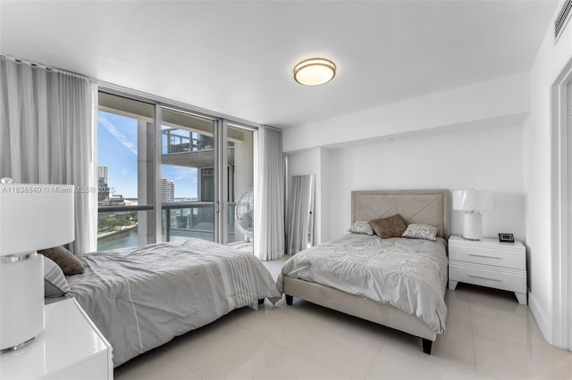 495 Brickell Ave Unit Bay1007, Miami, FL 33131 - bedroom featuring a view of city, access to exterior, floor to ceiling windows, and light tile patterned flooring