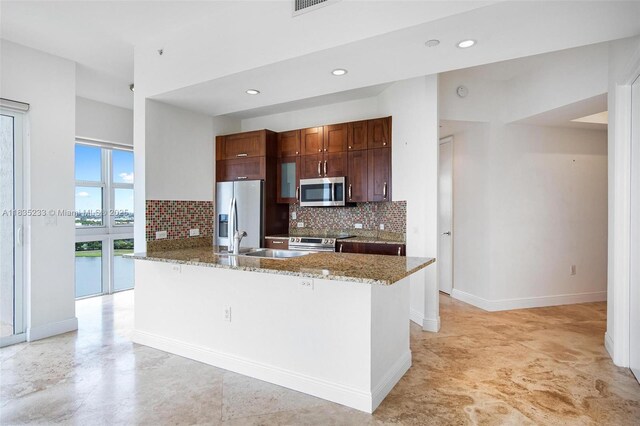 20000 E Country Club Dr Unit Ts02, Aventura, FL 33180 - kitchen featuring stainless steel appliances, backsplash, light stone countertops, recessed lighting, and a breakfast bar area