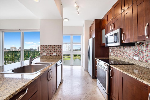 20000 E Country Club Dr Unit Ts02, Aventura, FL 33180 - kitchen featuring appliances with stainless steel finishes, backsplash, light stone countertops, and a view of city