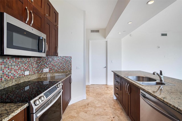 20000 E Country Club Dr Unit Ts02, Aventura, FL 33180 - kitchen with appliances with stainless steel finishes, decorative backsplash, light stone counters, recessed lighting, and dark brown cabinets