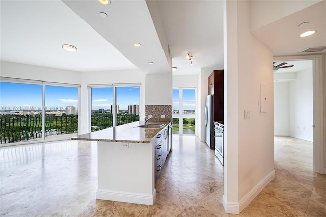 20000 E Country Club Dr Unit Ts02, Aventura, FL 33180 - kitchen featuring light stone countertops, appliances with stainless steel finishes, a city view, and recessed lighting