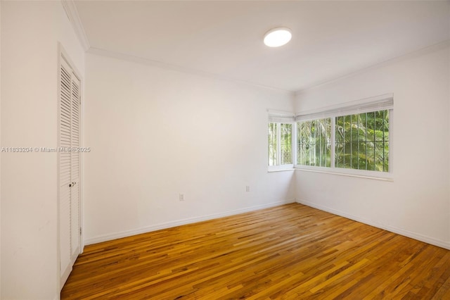 4050 Loquat Ave, Coconut Grove, FL 33133 - unfurnished bedroom featuring ornamental molding, hardwood / wood-style floors, and a closet