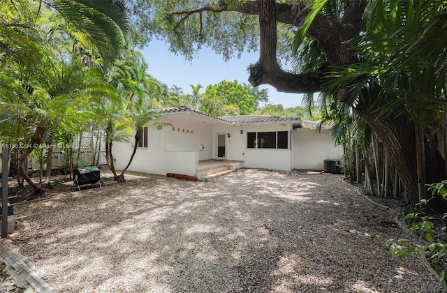 4050 Loquat Ave, Coconut Grove, FL 33133 - rear view of house with stucco siding, a tiled roof, a patio area, and driveway