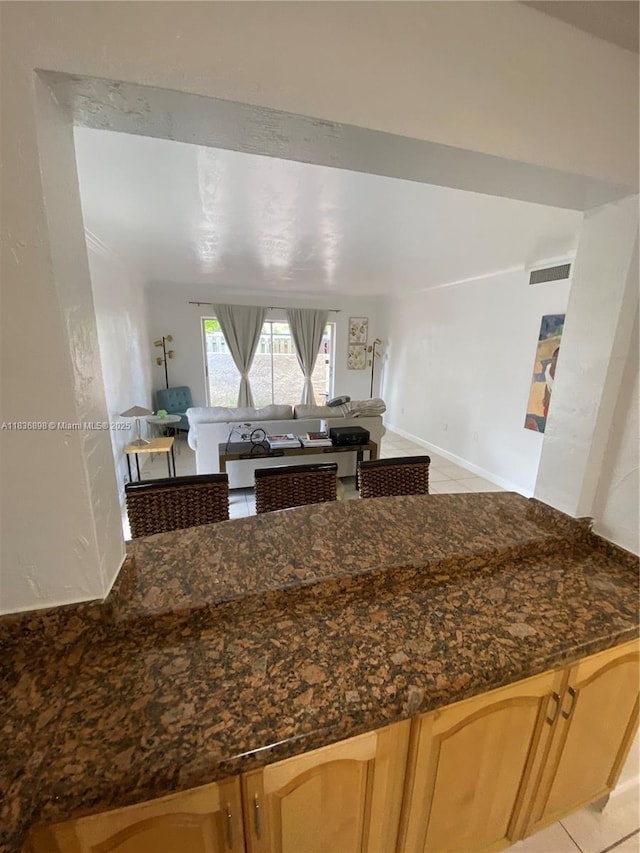 6900 N Kendall Dr Unit A102, Pinecrest, FL 33156 - kitchen featuring light tile patterned flooring, dark stone countertops, and open floor plan