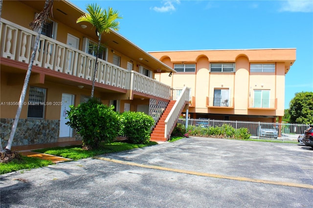1154 W 35th St Unit 221, Hialeah, FL 33012 - view of property featuring stairs and uncovered parking