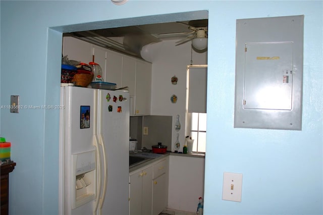 1154 W 35th St Unit 221, Hialeah, FL 33012 - kitchen with white refrigerator with ice dispenser, electric panel, ceiling fan, and white cabinetry