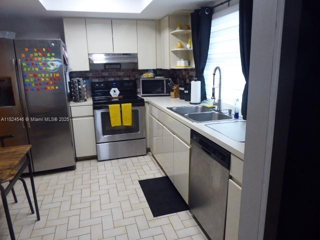 15299 SW 45th Ter Unit G-63, Miami, FL 33185 - kitchen featuring appliances with stainless steel finishes, under cabinet range hood, light countertops, and decorative backsplash