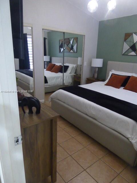15299 SW 45th Ter Unit G-63, Miami, FL 33185 - bedroom with light tile patterned floors and lofted ceiling