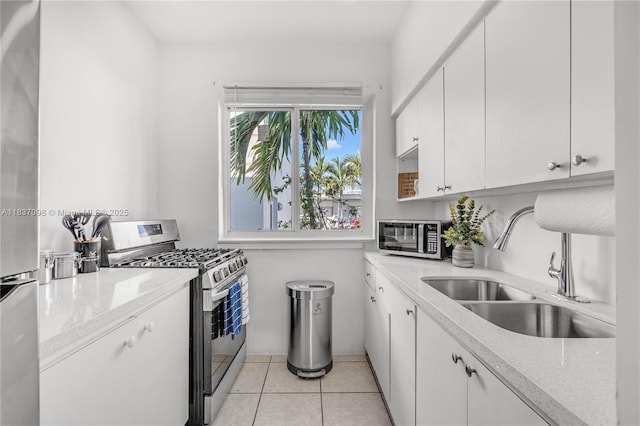 825 Jefferson Ave Unit 4, Miami Beach, FL 33139 - kitchen featuring stainless steel appliances, white cabinets, light tile patterned floors, and light stone countertops