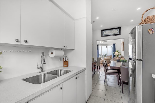 825 Jefferson Ave Unit 4, Miami Beach, FL 33139 - kitchen featuring freestanding refrigerator, white cabinetry, recessed lighting, light tile patterned floors, and light stone countertops