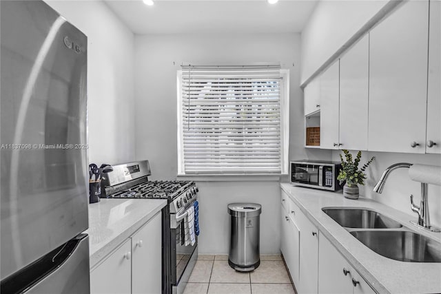 825 Jefferson Ave Unit 4, Miami Beach, FL 33139 - kitchen with appliances with stainless steel finishes, white cabinetry, recessed lighting, and light tile patterned flooring