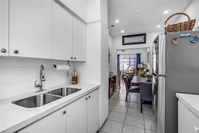 825 Jefferson Ave Unit 4, Miami Beach, FL 33139 - kitchen featuring freestanding refrigerator, white cabinetry, recessed lighting, and light tile patterned flooring