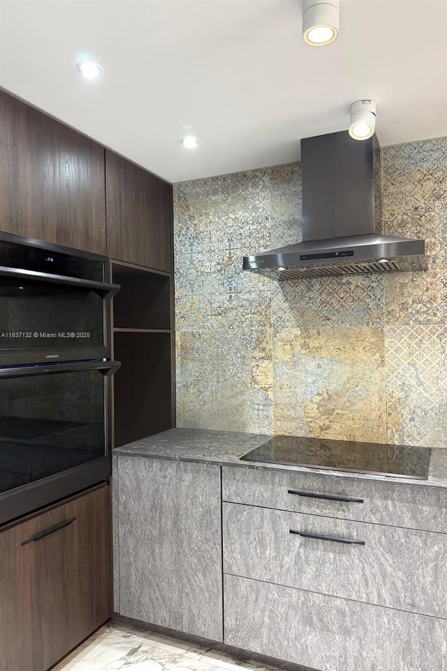 20379 W Country Club Dr Unit 2333, Aventura, FL 33180 - kitchen featuring wall chimney range hood, light marble finish flooring, black appliances, recessed lighting, and dark countertops