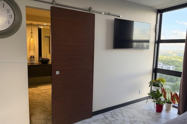 20379 W Country Club Dr Unit 2333, Aventura, FL 33180 - corridor featuring floor to ceiling windows, marble look tiles, and a barn door