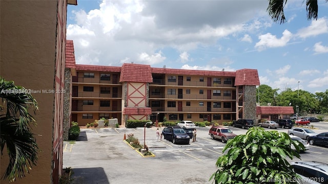 1325 W 68th St Unit 214, Hialeah, FL 33014 - view of building exterior with uncovered parking