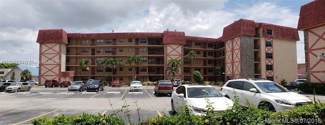 1325 W 68th St Unit 214, Hialeah, FL 33014 - view of building exterior featuring uncovered parking