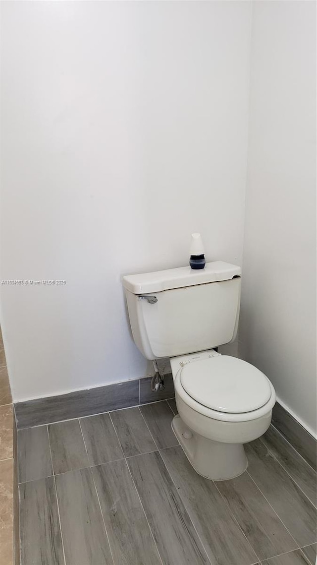1325 W 68th St Unit 214, Hialeah, FL 33014 - bathroom featuring toilet and wood tiled floors