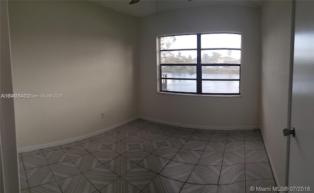 1325 W 68th St Unit 214, Hialeah, FL 33014 - empty room featuring a water view and baseboards