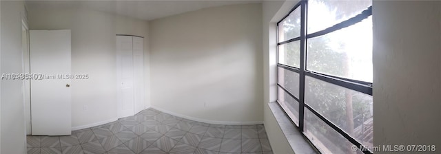 1325 W 68th St Unit 214, Hialeah, FL 33014 - spare room with baseboards